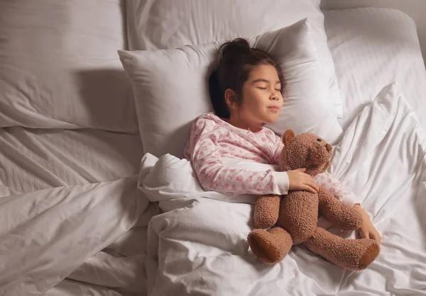 Cute little Asian girl sleeping in bed — Stock Photo, Image