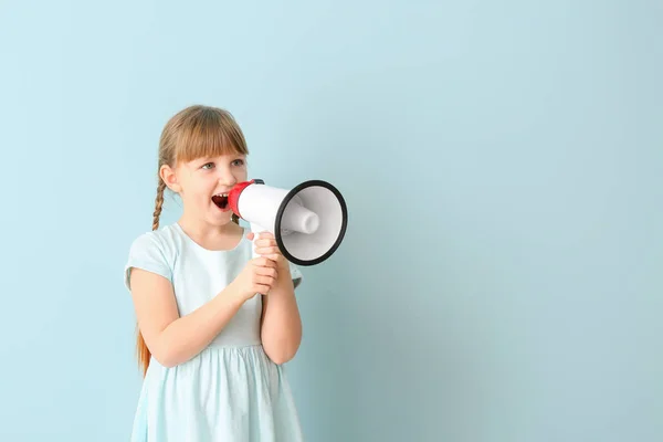 Cute little girl with megaphone on color background — Stock Photo, Image