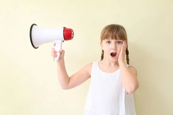 Menina surpreendida com megafone no fundo de luz — Fotografia de Stock