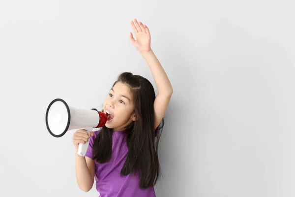 Cute little girl with megaphone on white background — Stock Photo, Image