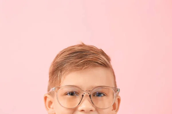 Cute little boy with eyeglasses on color background — Stock Photo, Image