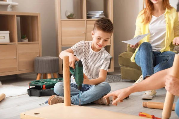 Family assembling furniture at home — Stock Photo, Image