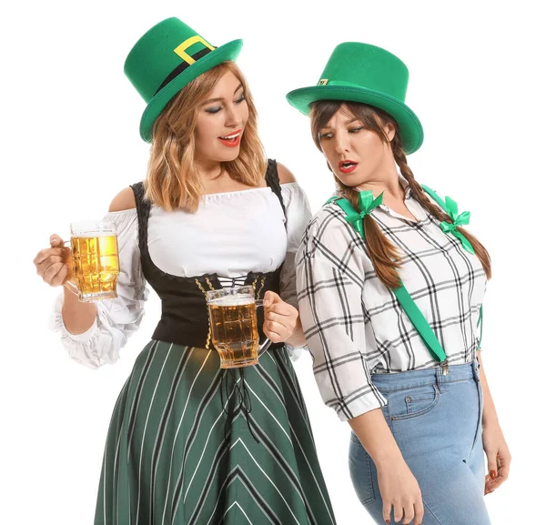 Funny young women with beer on white background. St. Patrick's Day celebration — Stock Photo, Image