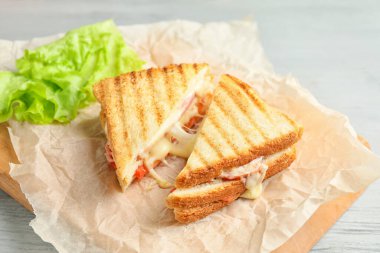 Tasty sandwiches with cheese on table
