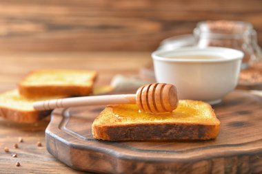 Toasted bread with honey on table