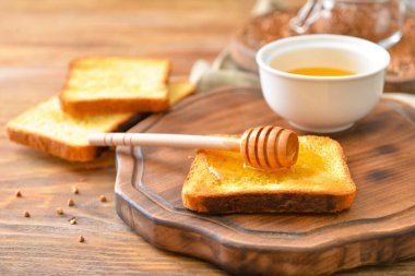 Toasted bread with honey on table