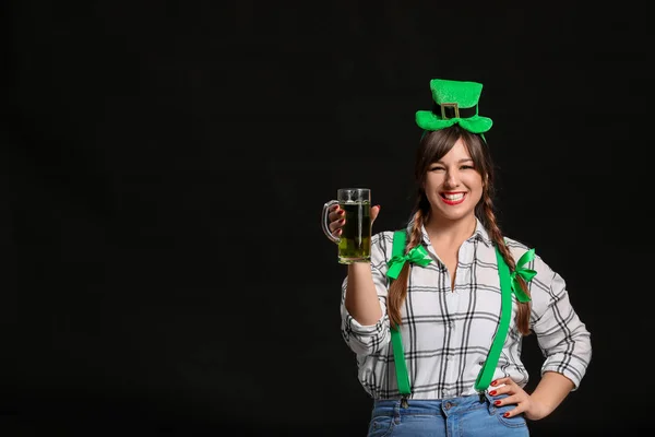 Jeune femme drôle avec de la bière sur fond sombre. Célébration de la Saint Patrick — Photo