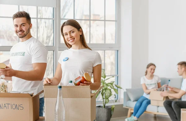 Team of volunteers with products indoors