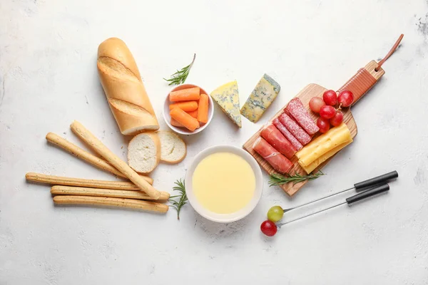 Сырный фондю с закусками на белом фоне — стоковое фото