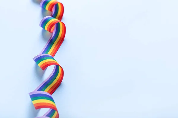 Rainbow ribbon of LGBT on color background — Stock Photo, Image