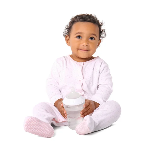 Cute African-American baby with bottle on white background — Stock Photo, Image
