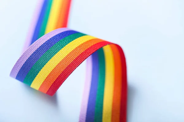 Rainbow ribbon of LGBT on color background