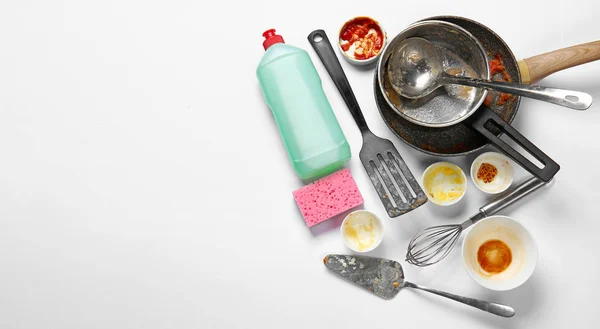 Dirty empty dishes with detergent and sponge on white background — 스톡 사진
