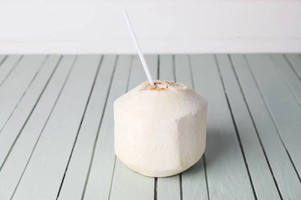 Young coconut with straw on table — Stock Photo, Image