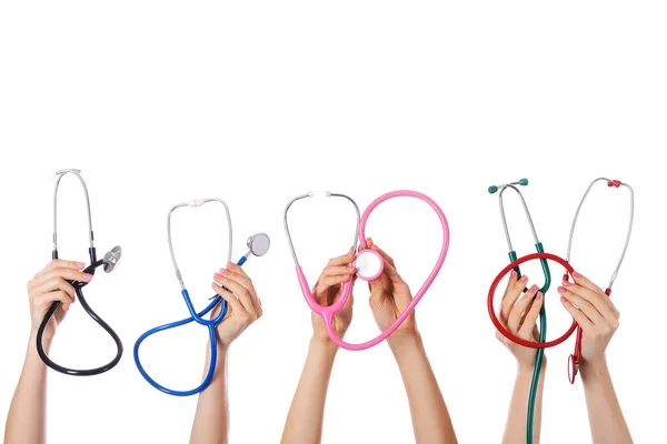 Many hands with stethoscopes on white background — Stock Photo, Image