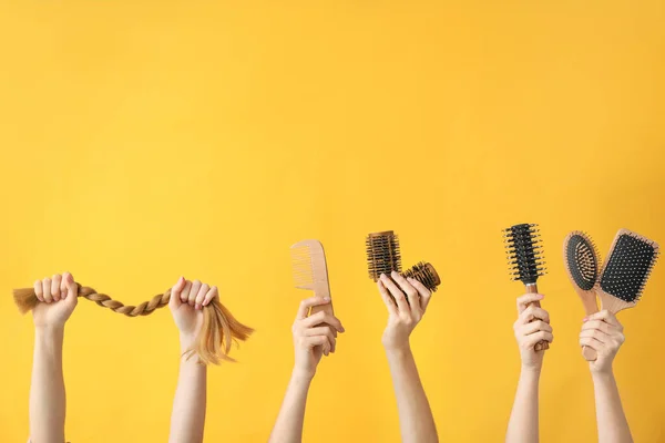 Many hands with hairdresser's supplies on color background — Stock Photo, Image