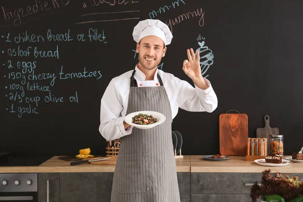 Happy male chef with prepared dish in kitchen — Stock Photo, Image
