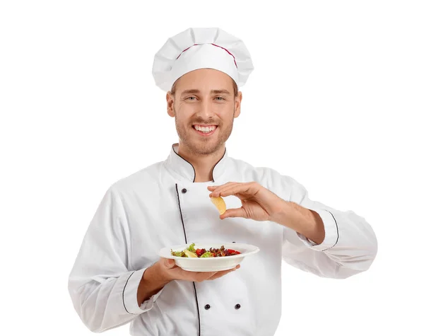 Bonito chef masculino com prato preparado e pedaço de limão sobre fundo branco — Fotografia de Stock