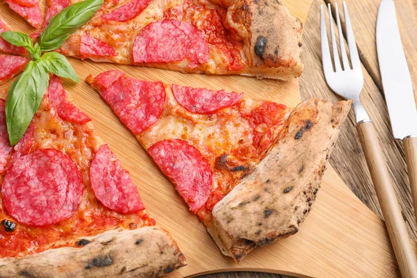 Tasty pizza on wooden board, closeup — Stock Photo, Image