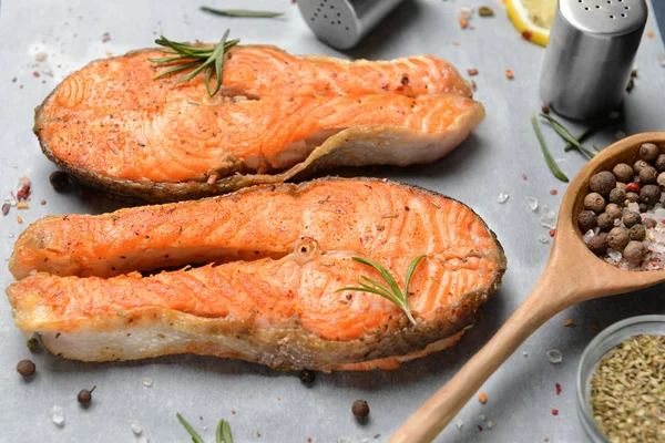 Tasty fried salmon with spices on table — Stock Photo, Image