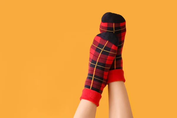 Legs of young woman in socks on color background — Stock Photo, Image