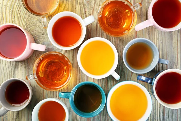 Cups with different types of hot tea on table — Stock Photo, Image