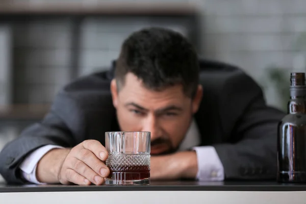 Businessman drinking cognac in office. Concept of alcoholism — Stock Photo, Image