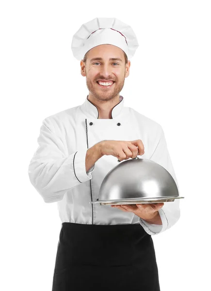 Bonito chef masculino com bandeja e cloche no fundo branco — Fotografia de Stock