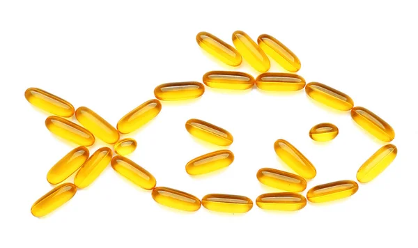 Fish shape made of oil pills on white background — Stock Photo, Image