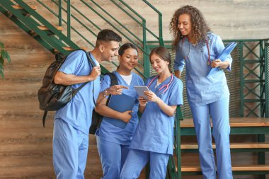 Bir grup tıp öğrencisi modern kliniğin koridorunda.