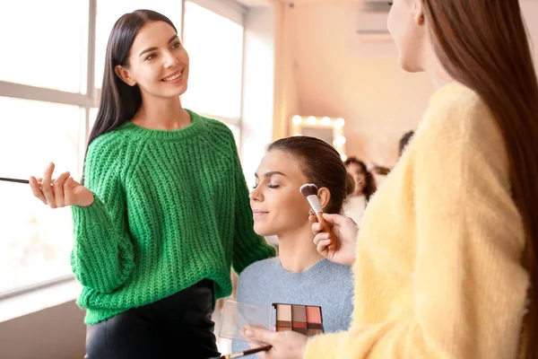 Junge Frau unterrichtet Studentin in Make-up-Schule — Stockfoto