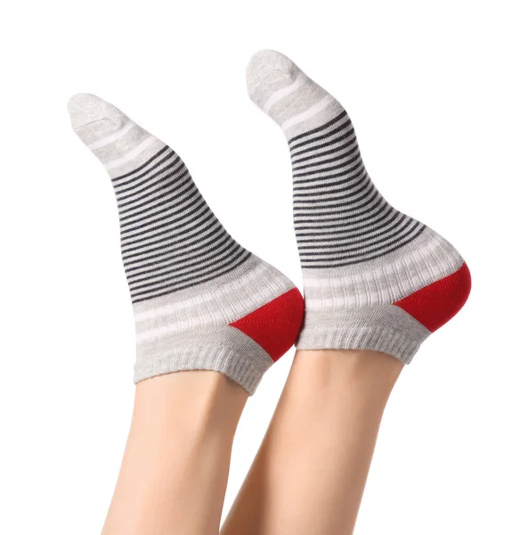 Benen van jonge vrouw in sokken op witte achtergrond — Stockfoto