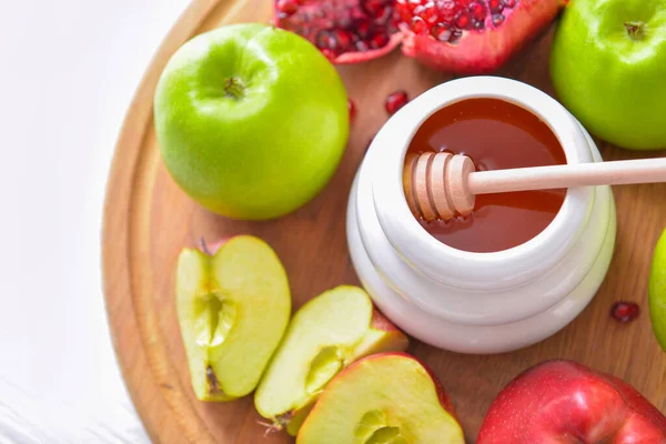 Sweet honey, apples and pomegranate on table Royalty Free Stock Photos