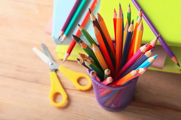 Pencils and school supplies on wooden table — Stock Photo, Image