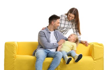 Happy young family with sofa on white background
