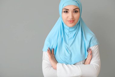Beautiful Arab woman on grey background