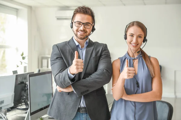 Portrait of technical support agents showing thumb-up in office — Stock Photo, Image