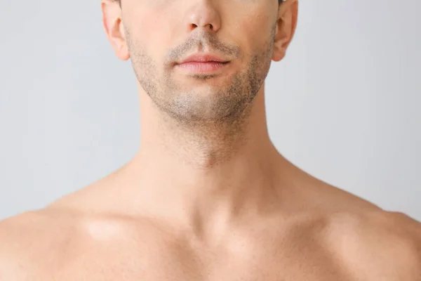 Beau jeune homme sur fond clair. Concept de chirurgie plastique — Photo