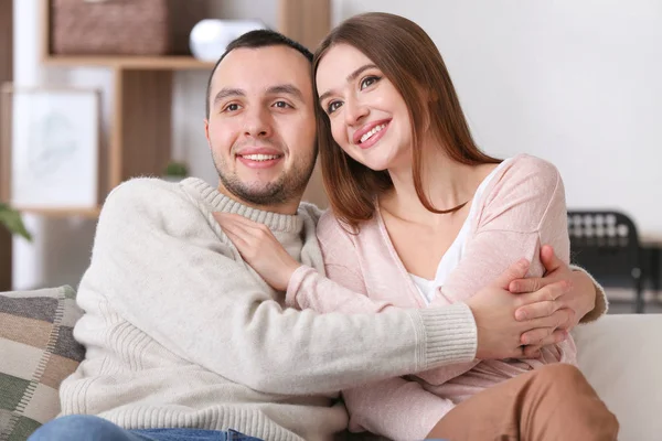 Beautiful young couple watching TV at home — Stock Photo, Image