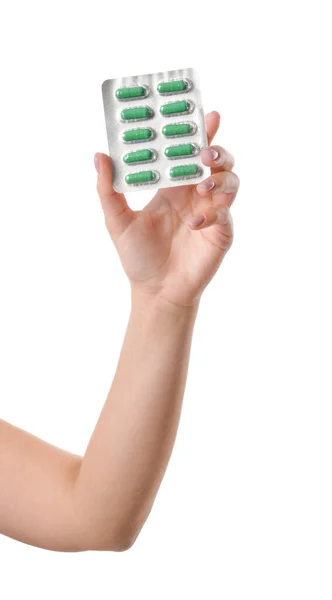 Female hand with pills in blister pack on white background — 스톡 사진