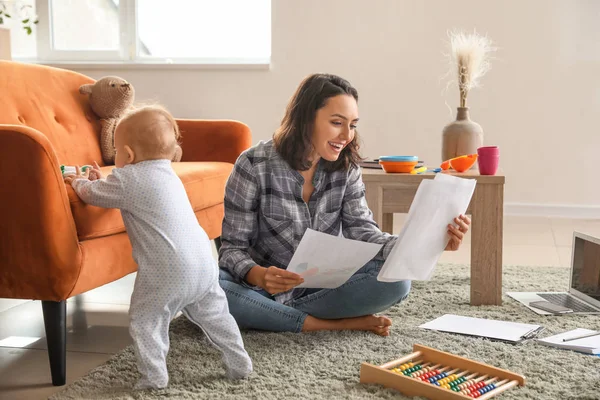 Working mother with her baby at home