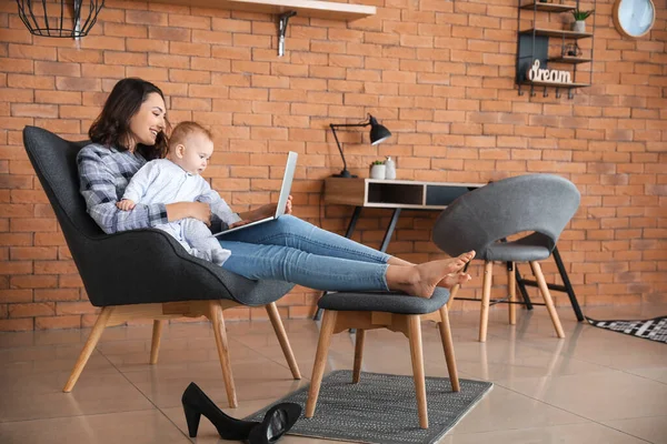 Working mother with her baby at home