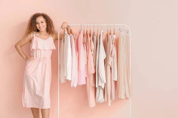 African-American stylist near rack with modern clothes — Stock Photo, Image