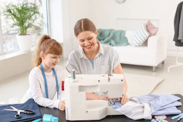 Little daughter helping her mother in tailor's workshop — 스톡 사진