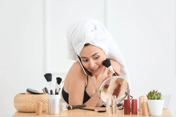 Morning of beautiful young woman applying makeup and talking by phone at home — Stock Photo, Image