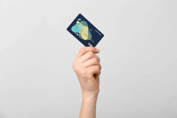 Female hand with credit card on light background — Stock Photo, Image