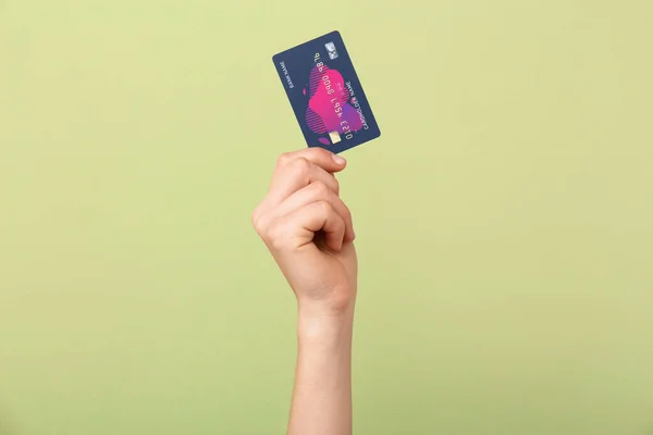 Female hand with credit card on color background — Stock Photo, Image