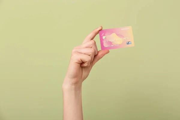 Female hand with credit card on color background — Stock Photo, Image