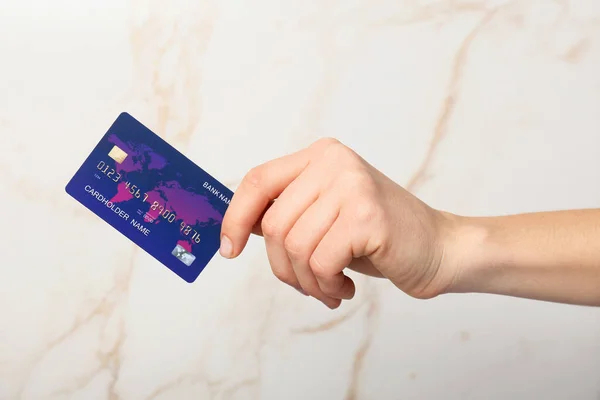 Female hand with credit card on light background — Stock Photo, Image