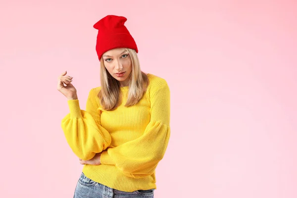 Junge Frau im warmen Pullover auf farbigem Hintergrund — Stockfoto